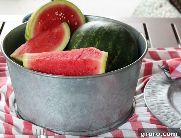 Chilling watermelon in a galvanized bucket for refreshing outdoor entertaining