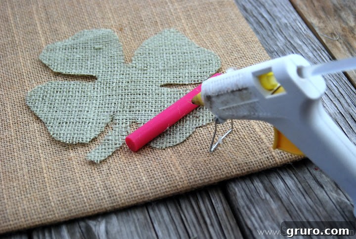 Positioning the green burlap clover on the tan burlap background