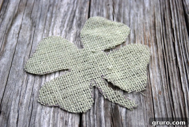 Close-up of traced four leaf clover on green burlap
