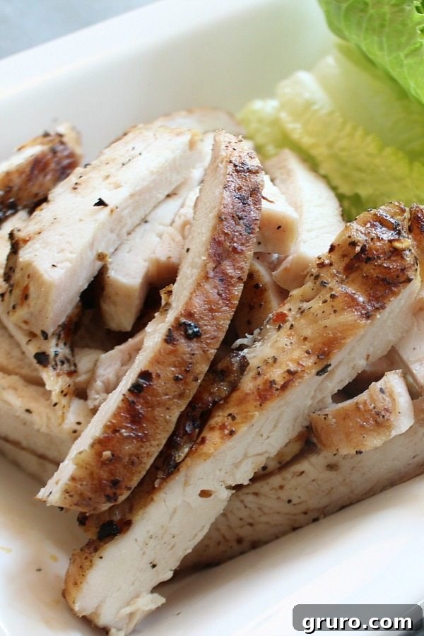 Grilled chicken breasts seasoned with red pepper flakes, ready for a spicy lettuce wrapped chicken recipe.