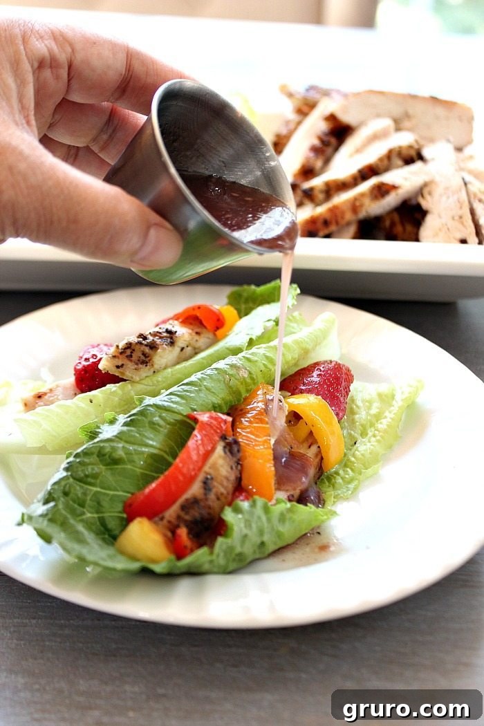 Lettuce Chicken Wraps featuring grilled chicken, vibrant pineapples, and fresh strawberries, drizzled with Raspberry Vinaigrette.