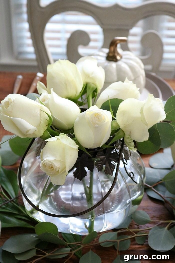 Autumn Glow Centerpiece 2 Elegant white roses in a DIY pumpkin vase centerpiece for a low-profile fall table