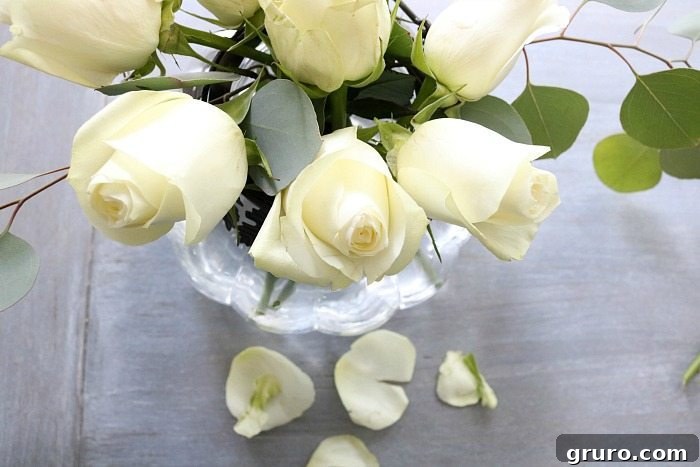 Autumn Glow Centerpiece 6 Perfect combination: low-profile white roses and greenery in a pumpkin vase for fall