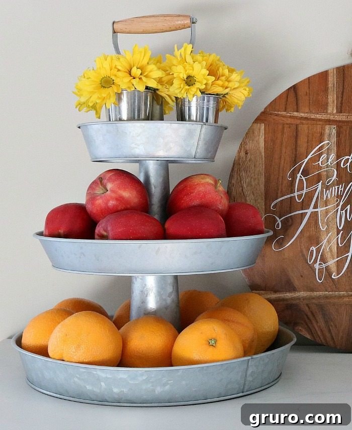 Three-tiered galvanized tray filled with assorted fruits