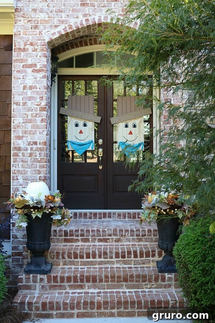Inviting fall door decoration featuring the custom-painted scarecrow, adding a festive touch to any home entrance.