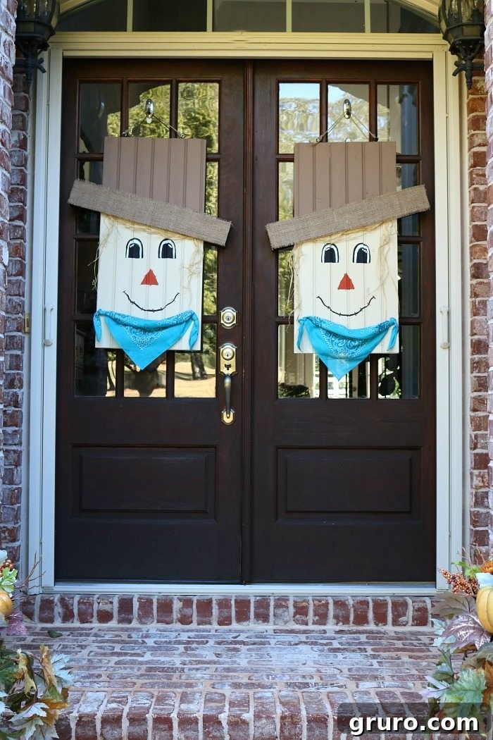 Detailed shot of the scarecrow door hanging, highlighting its unique facial features and rustic embellishments.