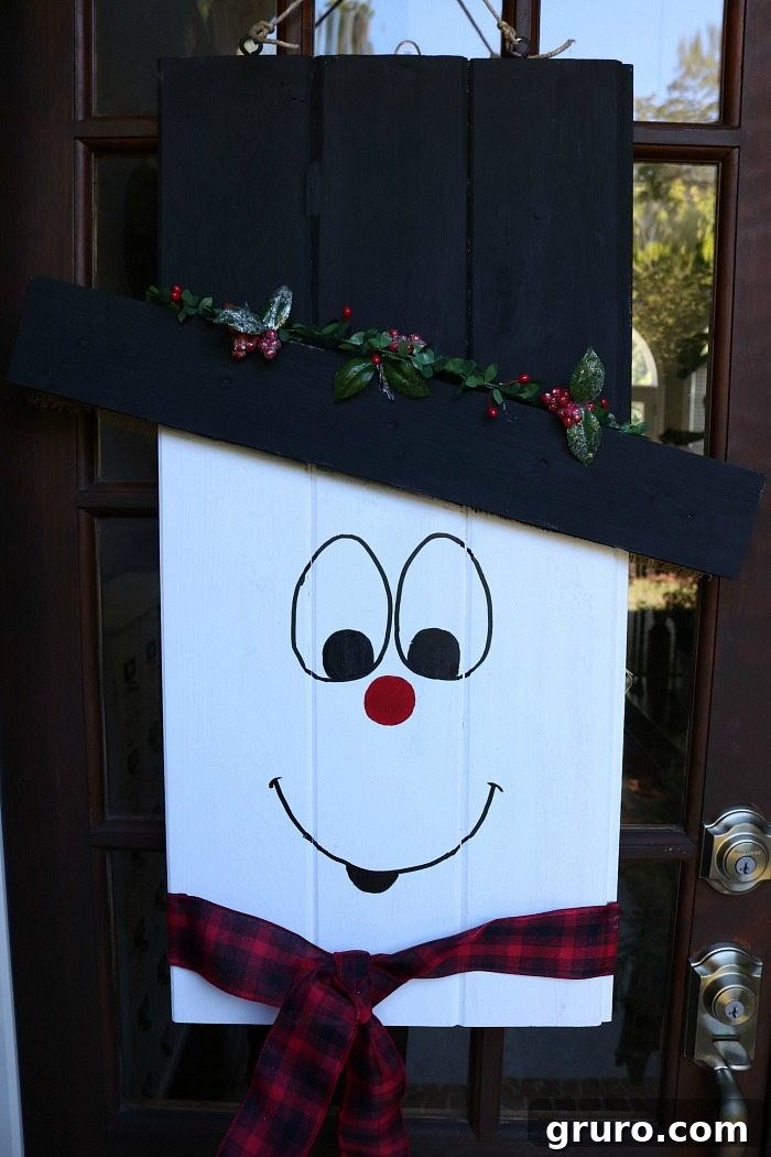 Finished reversible snowman door hanger, ready for winter, showcasing the creative possibilities of the DIY project.