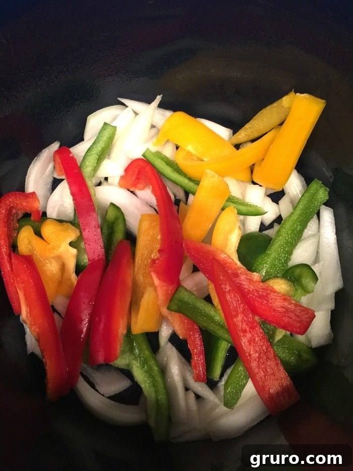 Sliced onions and peppers ready for slow cooker chicken fajitas