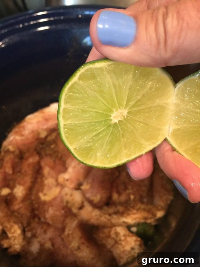 Squeezing fresh lime juice over chicken in slow cooker