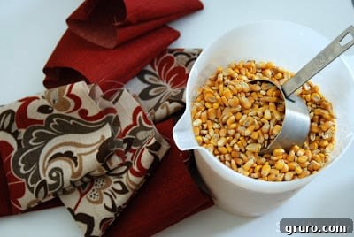 Filling a bean bag with feed corn using a measuring cup
