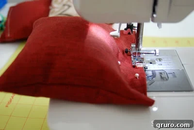A bean bag being sewn on a sewing machine, showing the care needed to avoid corn kernels
