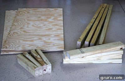 Various woodworking supplies laid out for constructing bean bag toss boards