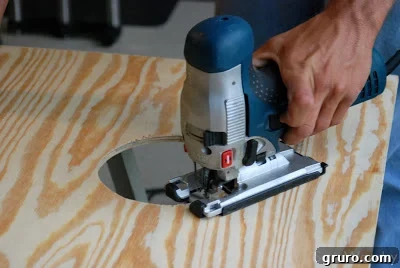 Close-up of a cornhole board frame being assembled with wood screws
