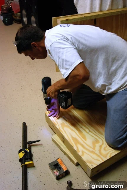 Measuring and marking the plywood surface for the cornhole board hole