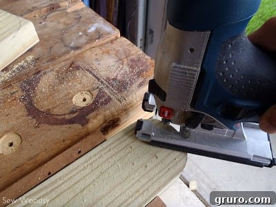 Plywood top surface being screwed onto the wooden frame of a cornhole board
