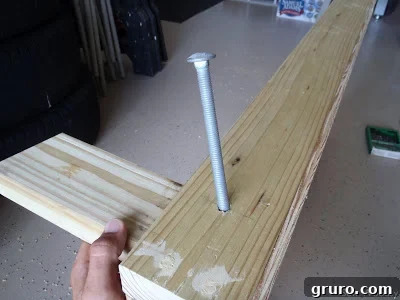 Drilling a hole through the wooden frame of a cornhole board for leg attachment