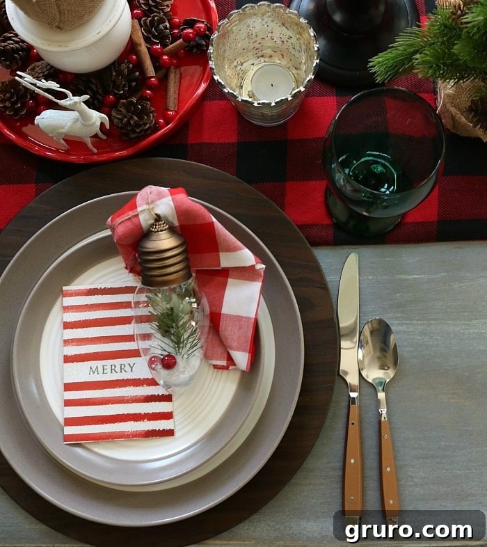 Christmas Ornament Napkin Rings Woodland-themed light bulb ornament used as a creative napkin ring for a Christmas farmhouse table