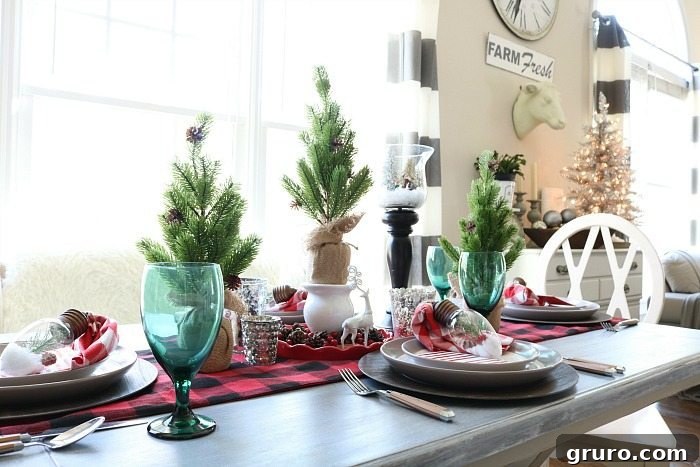 Plaid Runner and Burlap Trees Plaid table runner and burlap-wrapped trees creating a rustic Christmas setting