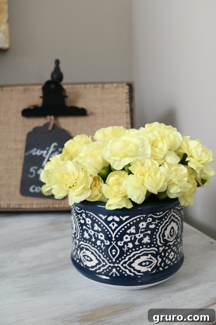Fresh flowers - perfect little container in blue and white on a nightstand