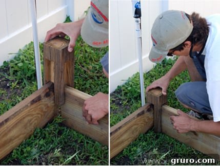 Close-up of a carved wooden joint, illustrating how lumber pieces fit together for the raised garden bed frame.