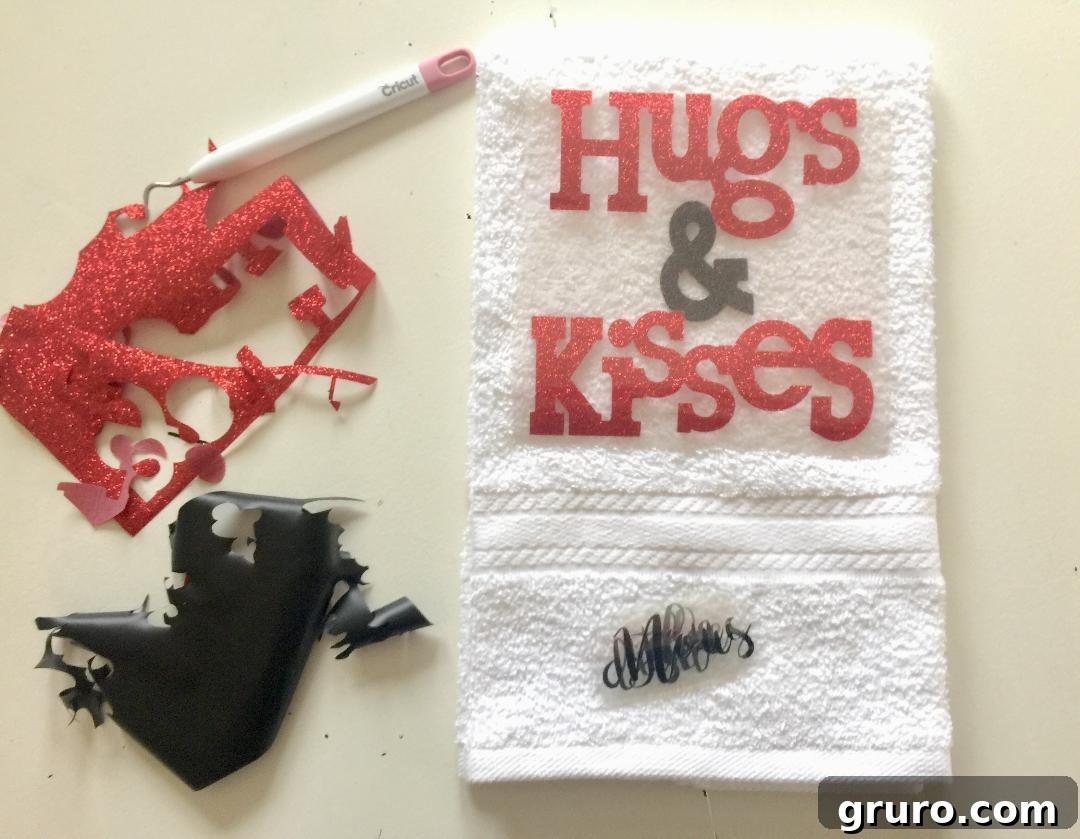 Weeding excess vinyl material from the 'Hugs & Kisses' design for the towel