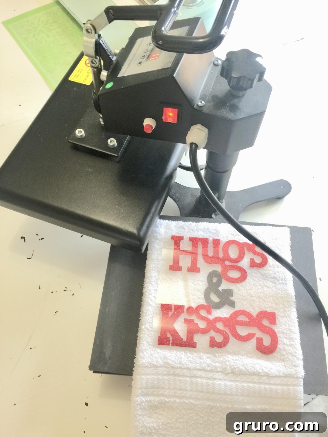 Applying Heat Transfer Vinyl to a hand towel using a heat press for a DIY Valentine's gift