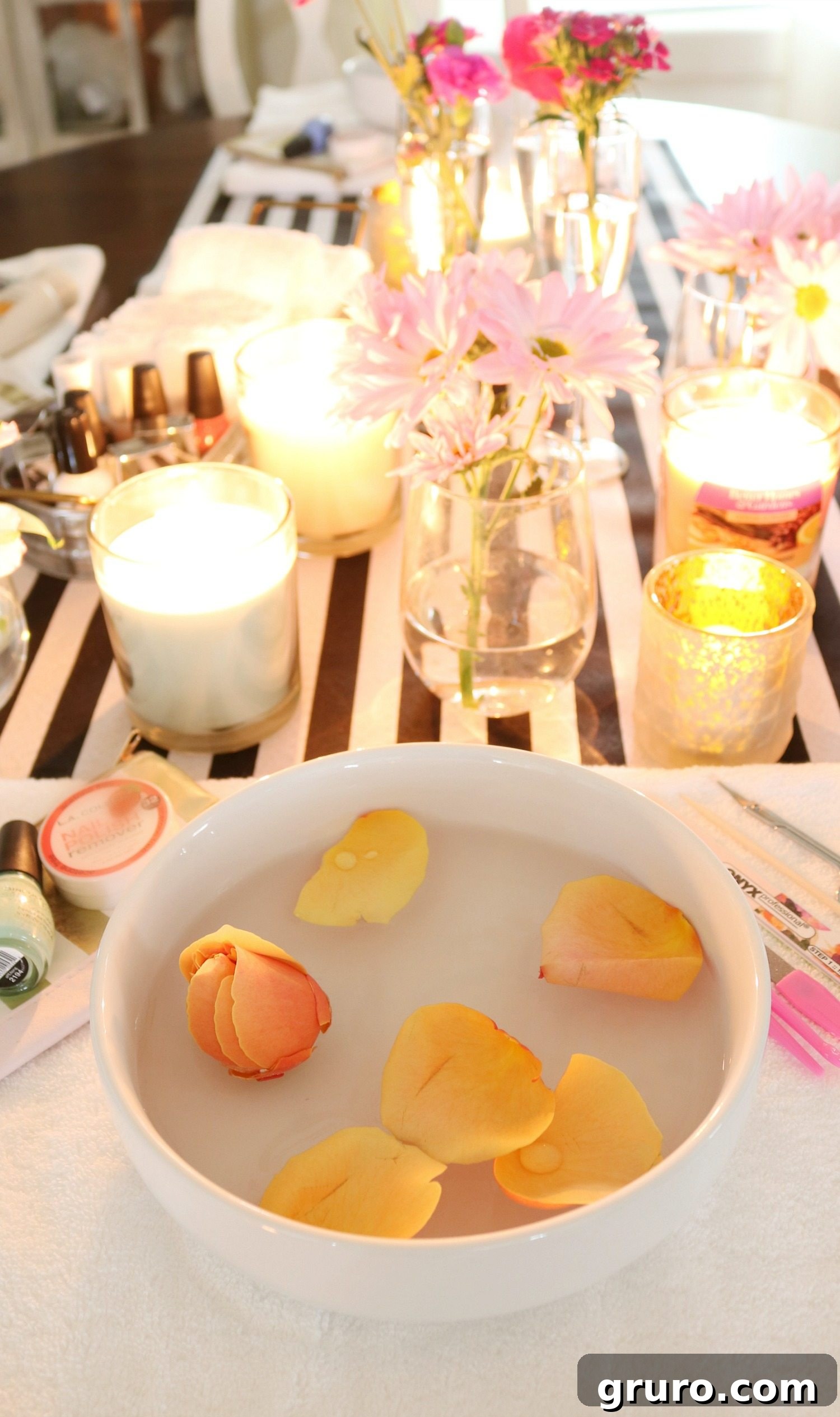 Rosewater infused hand soak for a luxurious spa night manicure, featuring delicate rose petals.