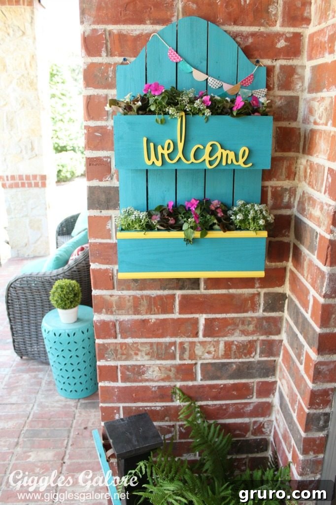 Front porch DIY spring planter box with colorful flowers and greenery