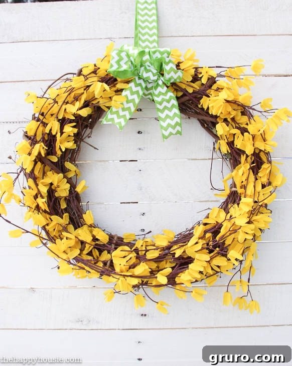 Handmade $5 spring forsythia wreath on a wooden door, radiating yellow cheer