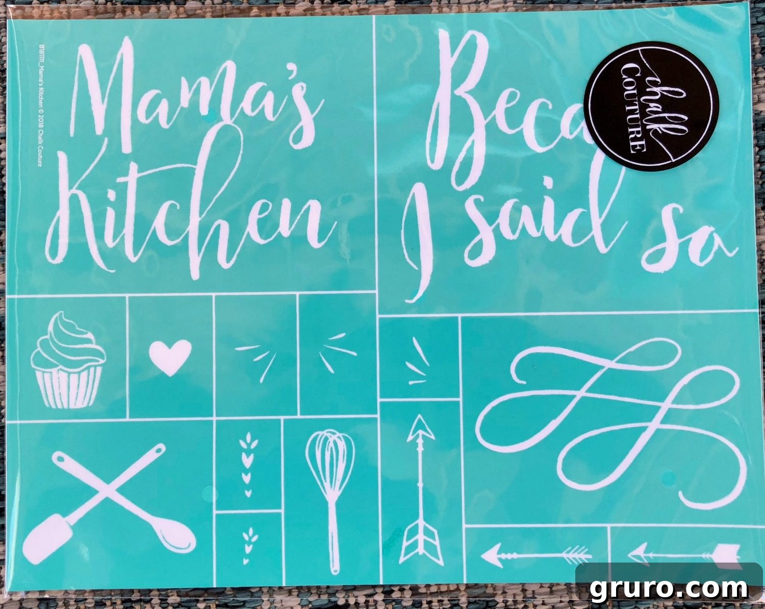 Close-up of Mama's Kitchen Chalk Couture transfer sheet, showcasing various design elements like text, utensils, and flourishes ready for use.