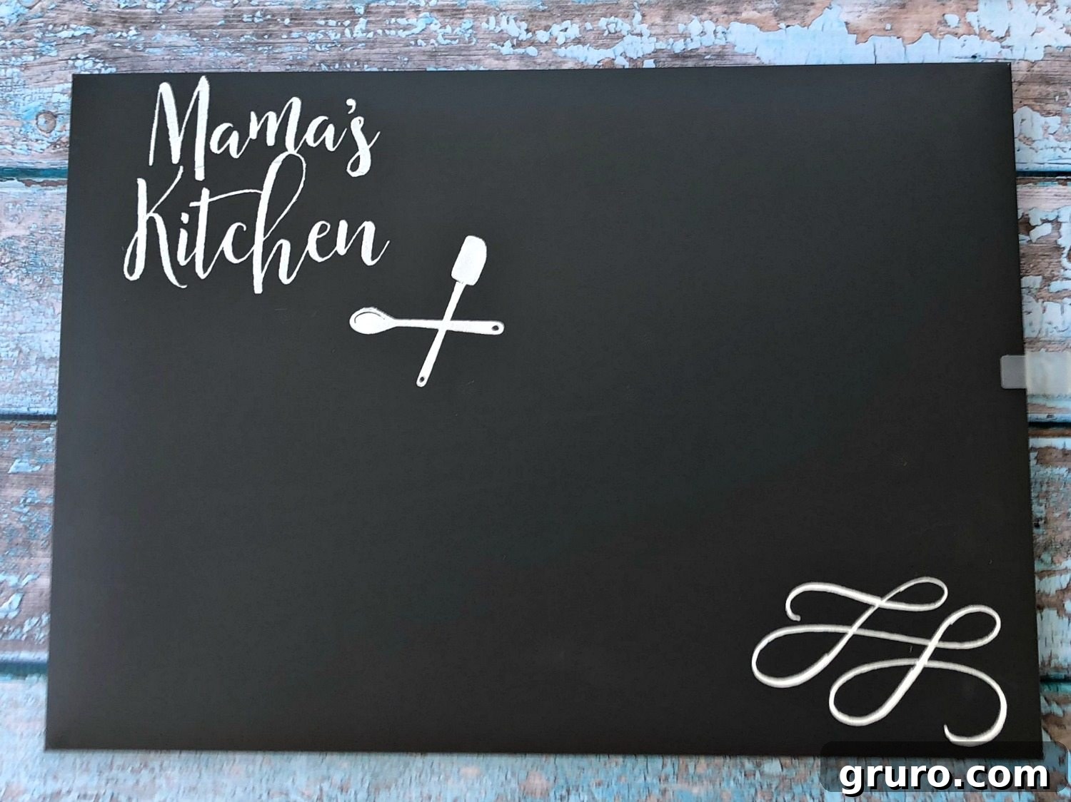 Beautifully finished 'Mama's Kitchen' chalkboard, ready to adorn a kitchen wall, highlighting the elegant design and crisp white text.