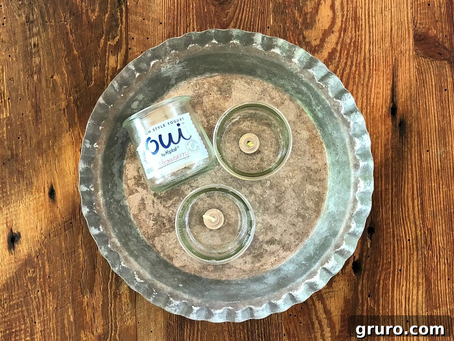 Collection of cute, recycled Oui yogurt jars ready for DIY candle making