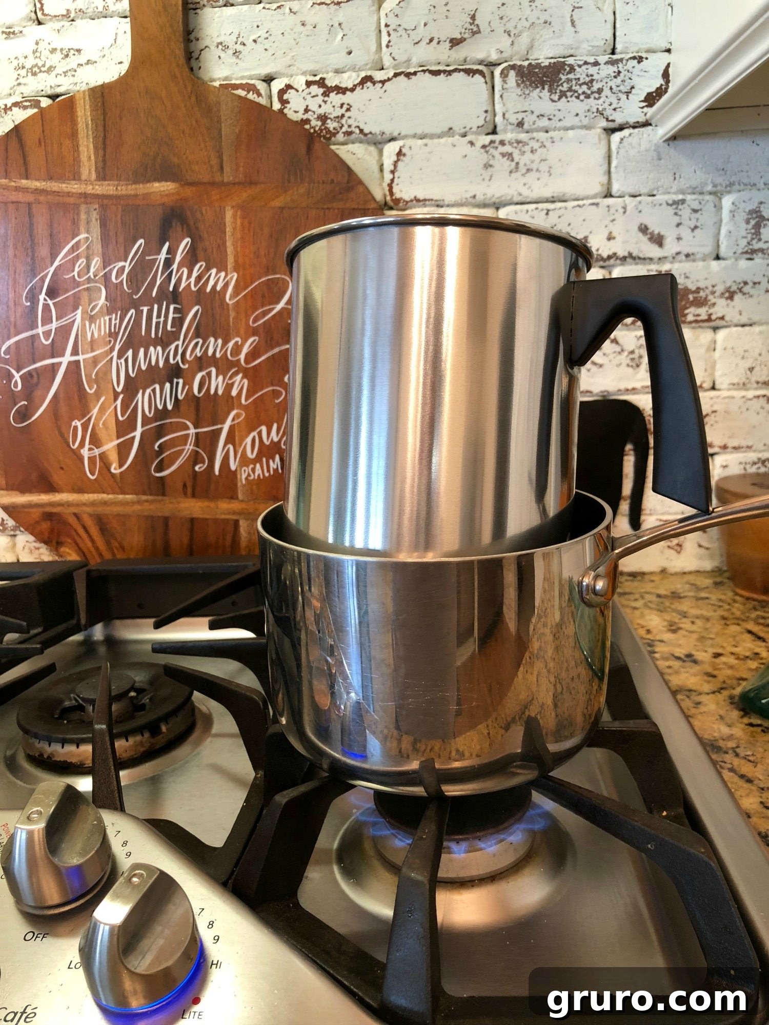 Using a double boiler setup to safely melt candle wax for DIY projects