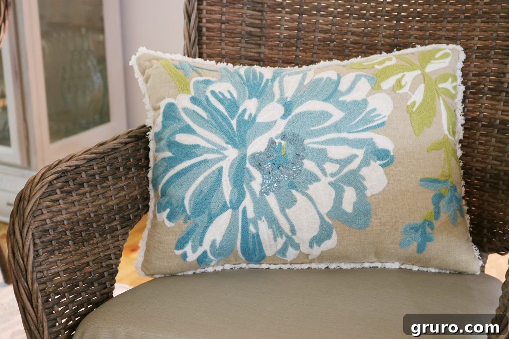Blue floral accent pillow adding texture and color to a casual dining room