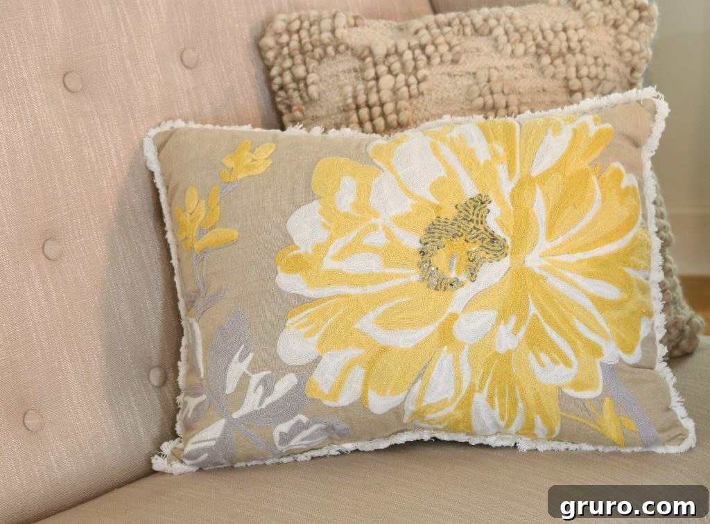 Close-up of a blue floral accent pillow in a farmhouse dining room