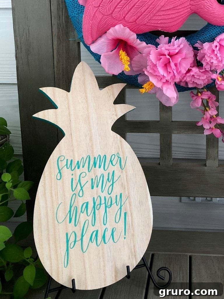 Decorative wooden pineapple with 'Summer is my Happy Place' text, complementing the flamingo wreath
