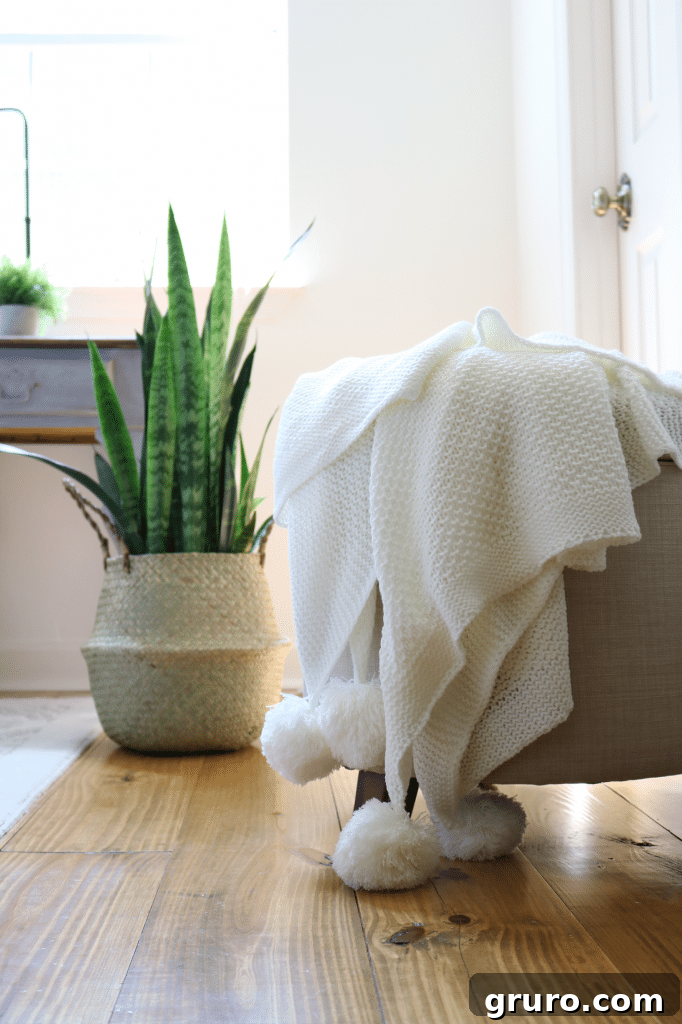 Ottoman and lightweight pompom throw blanket from Better Homes & Gardens, perfect for guest comfort
