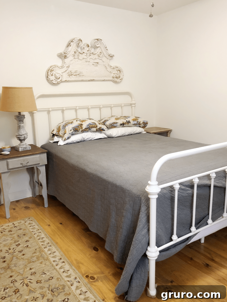 Before shot of a guest room with minimal decor and a somewhat cluttered feel