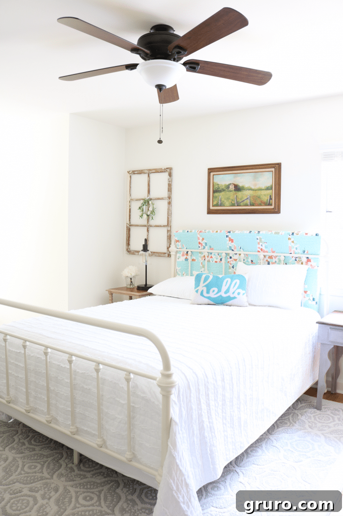 Refreshed guest room with farmhouse neutral items, bright bedding, and thoughtful decor