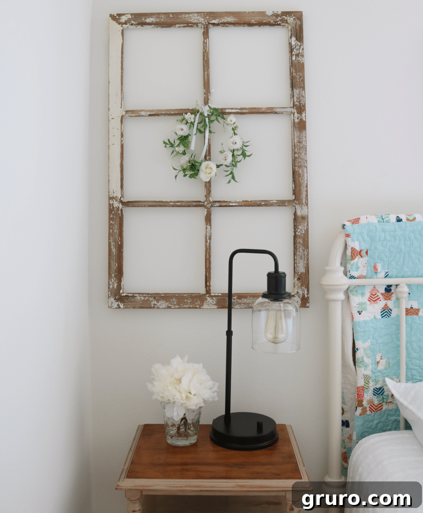 Well-decorated cottage farmhouse guest room featuring a refurbished dresser and a convenient luggage rack