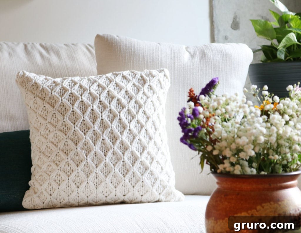 Cozy neutral sweater knit decorative pillow from Better Homes & Gardens, adding comfort to the sofa.