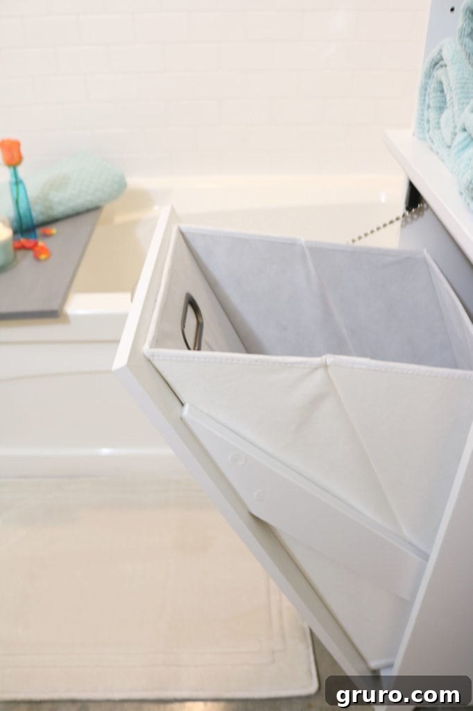 Laundry hamper with integrated storage, an affordable and practical bathroom cabinet solution.