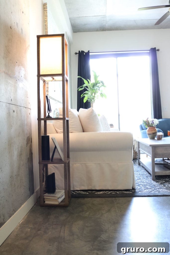 Softening a concrete loft apartment with a stylish floor lamp and carefully selected furnishings.