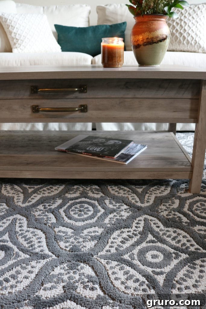 Close-up of the beautiful grey rug and rustic lift-top coffee table from Better Homes & Gardens.