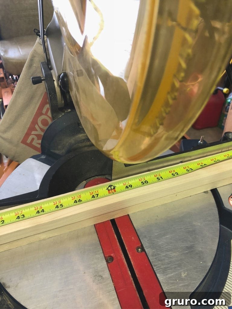 Use the miter saw to cut a frame for the shower curtain Cut common board for frame with the Ryobi miter saw, showing precision cutting.