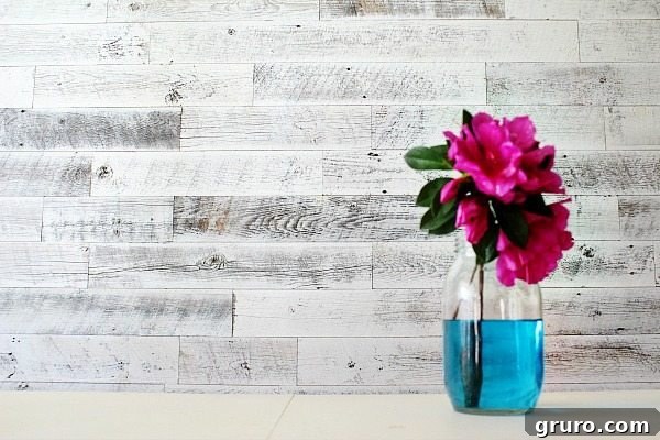 A farmhouse-style wall treatment featuring weathered white Stikwood, adding texture and character to a room.