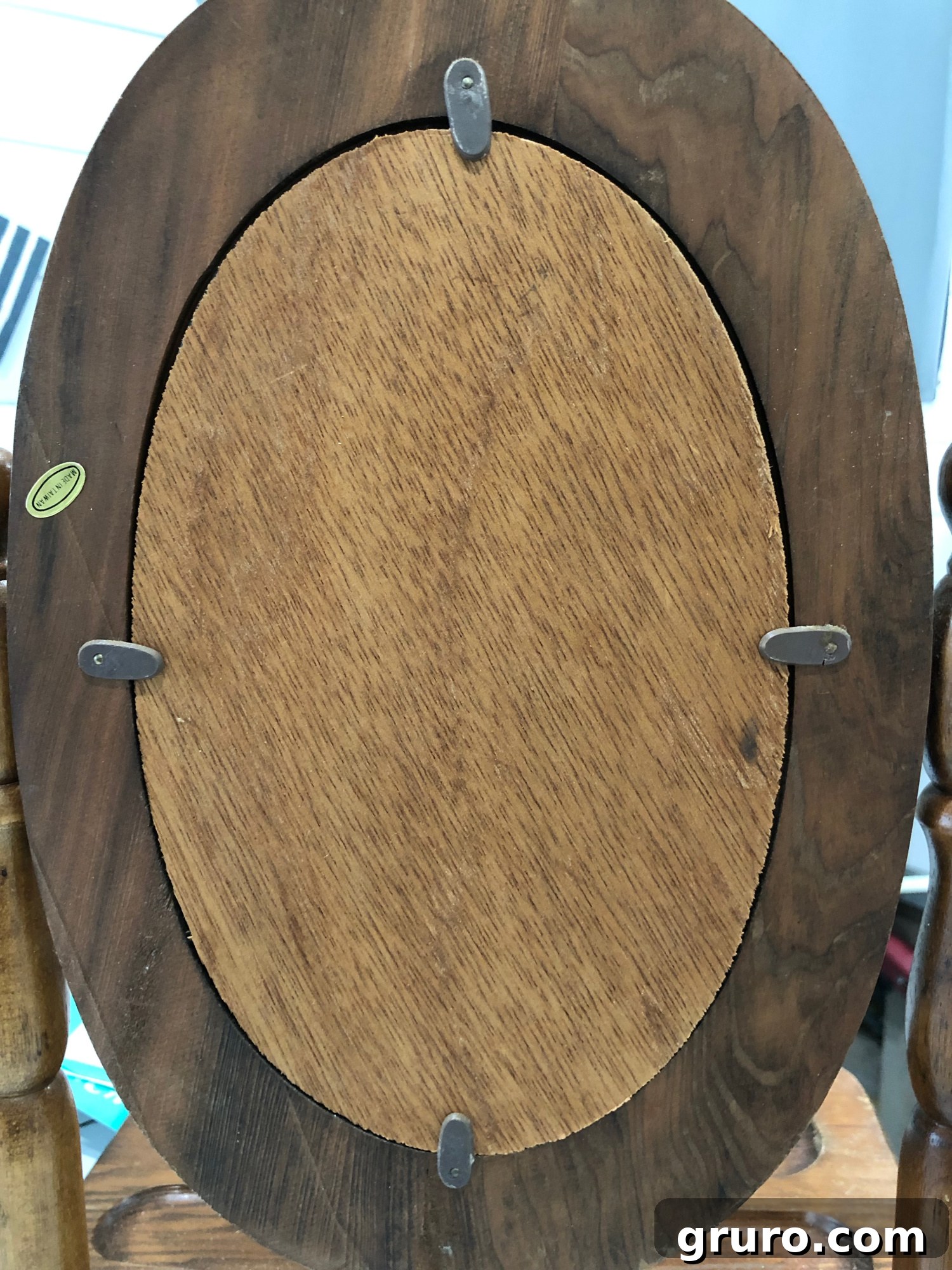 Back of the mirror stand showing details for removal