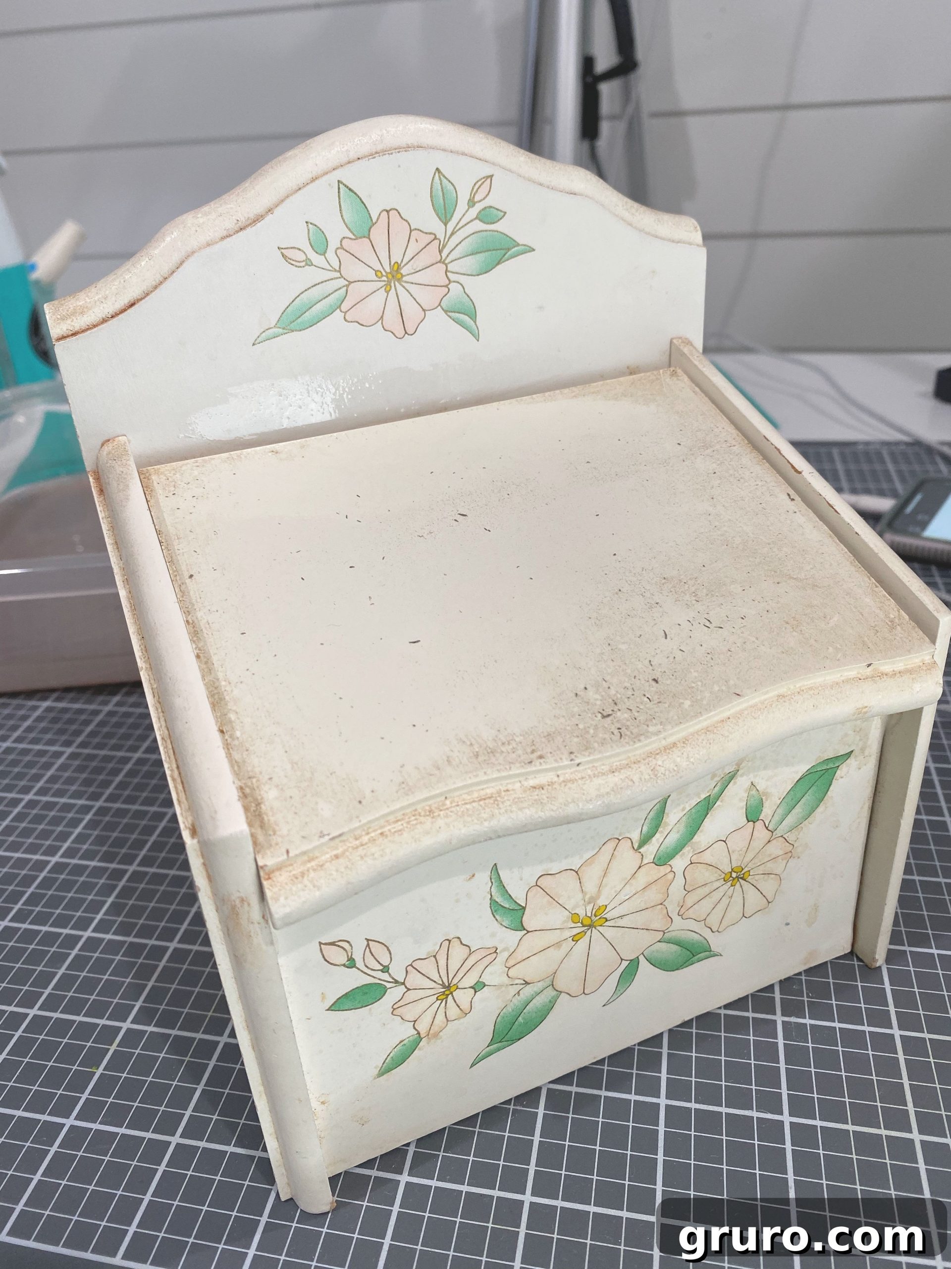 Close-up of a recipe box being cleaned with a cloth and cleaning solution