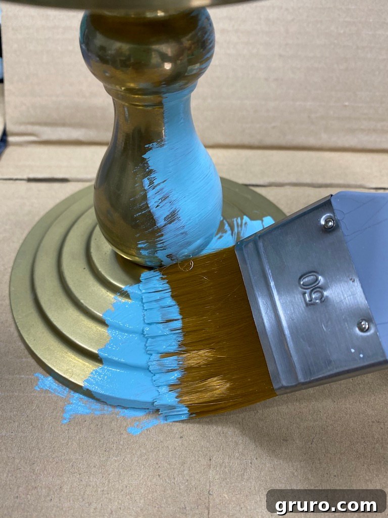 Various paint colors and a candlestick ready for transformation