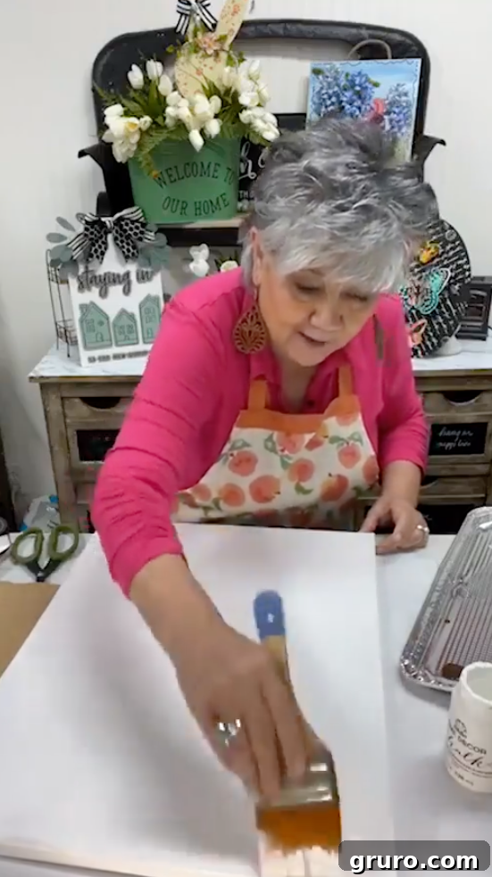 Using ripped cardboard to create streaks on canvas